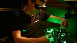 FIGURE 1. A Chromacity engineer aligns an ultrafast fiber laser with second-harmonic generation.