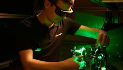 FIGURE 1. A Chromacity engineer aligns an ultrafast fiber laser with second-harmonic generation.