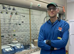 Artiom Skripka in front of a fume hood where the scientists synthesize their nanomaterials.