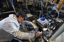 Postdoctoral researcher Xiao Qi in the laser room at the Molecular Foundry, with the team&rsquo;s optical setup for photon avalanching nanoparticles (in which a small increase in laser power causes a giant increase in the amount of light they emit).