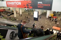 Attendees make their way into the SPIE Photonics West 2022 exhibition hall.